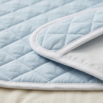 Close-up of Covelle washable bed pad quilting and binding