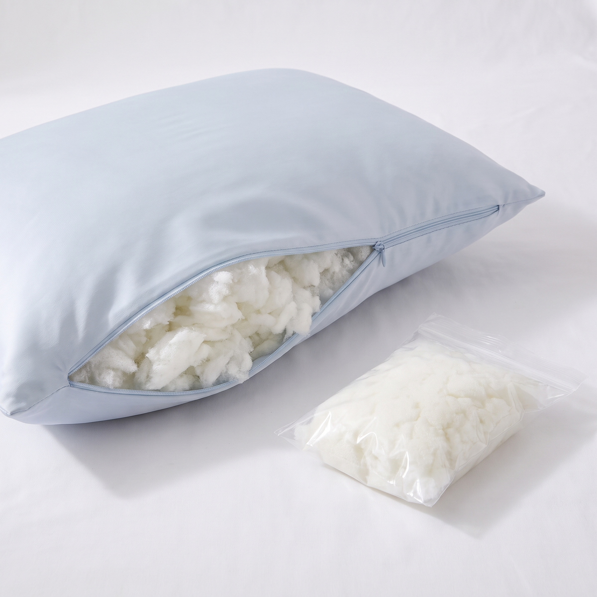 Unzipped Covelle Cooling Pillow showing adjustable fill and extra fill bag